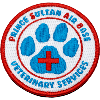 Embroidered round patch for Prince Sultan Air Base Veterinary Services featuring a blue paw print with a red cross on a white background and red border.