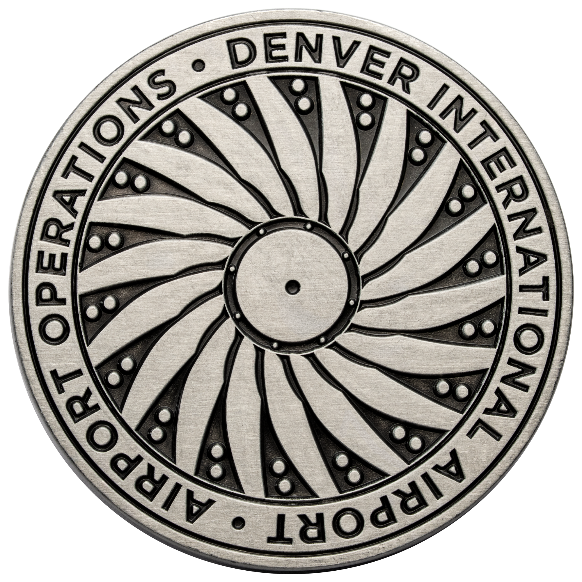 Antiqued silver challenge coin featuring a spiral turbine design and the text Denver International Airport Operations.