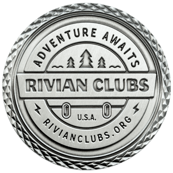 Antiqued silver challenge coin for Rivian Clubs featuring a mountain pine tree design and diamond-patterned edge.