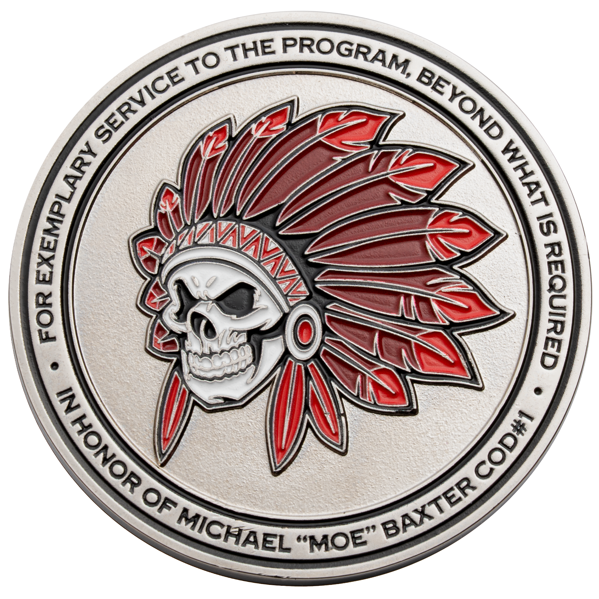 Circular silver challenge coin featuring a skull wearing a red and white feathered headdress with text honoring Michael Moe Baxter.