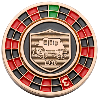 Challenge coin featuring a gold stagecoach shield with '1930' on a black background, surrounded by a red, black, and green roulette wheel border.