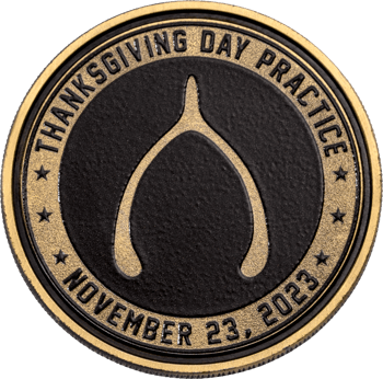 Custom Thanksgiving Day Practice challenge coin featuring a gold wishbone emblem on a textured black center with gold lettering.