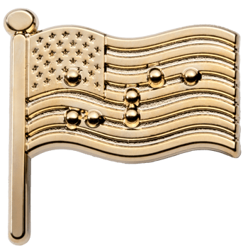 Gold lapel pin in the shape of a waving American flag featuring raised stars and Braille tactile dots on the stripes.