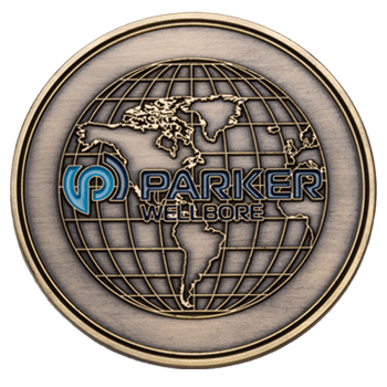 Antiqued bronze coin featuring a globe map and the Parker Wellbore logo with blue accents.