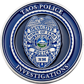 Taos Police Investigations challenge coin featuring a silver detective badge emblem on a dark blue background.