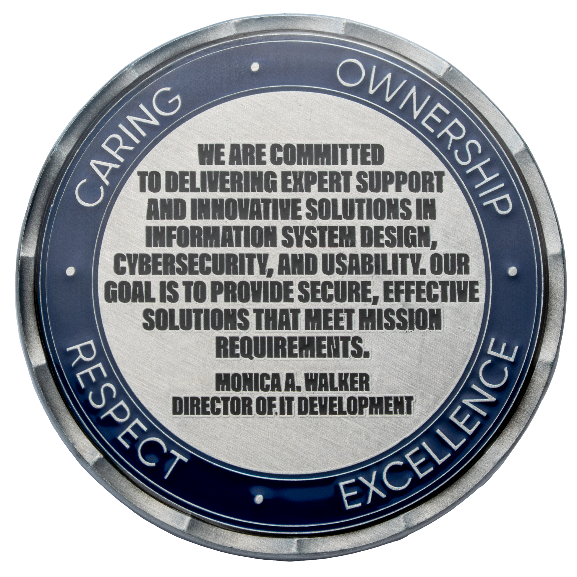 Silver and blue challenge coin featuring a mission statement with the values Caring, Ownership, Respect, and Excellence on the outer border.
