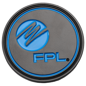 Circular black metal challenge coin with blue enamel FPL logo and stylized M emblem.