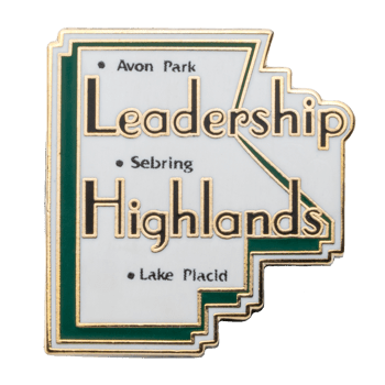 Leadership Highlands lapel pin featuring Avon Park, Sebring, and Lake Placid text on a white and green stepped geometric shape with gold trim.